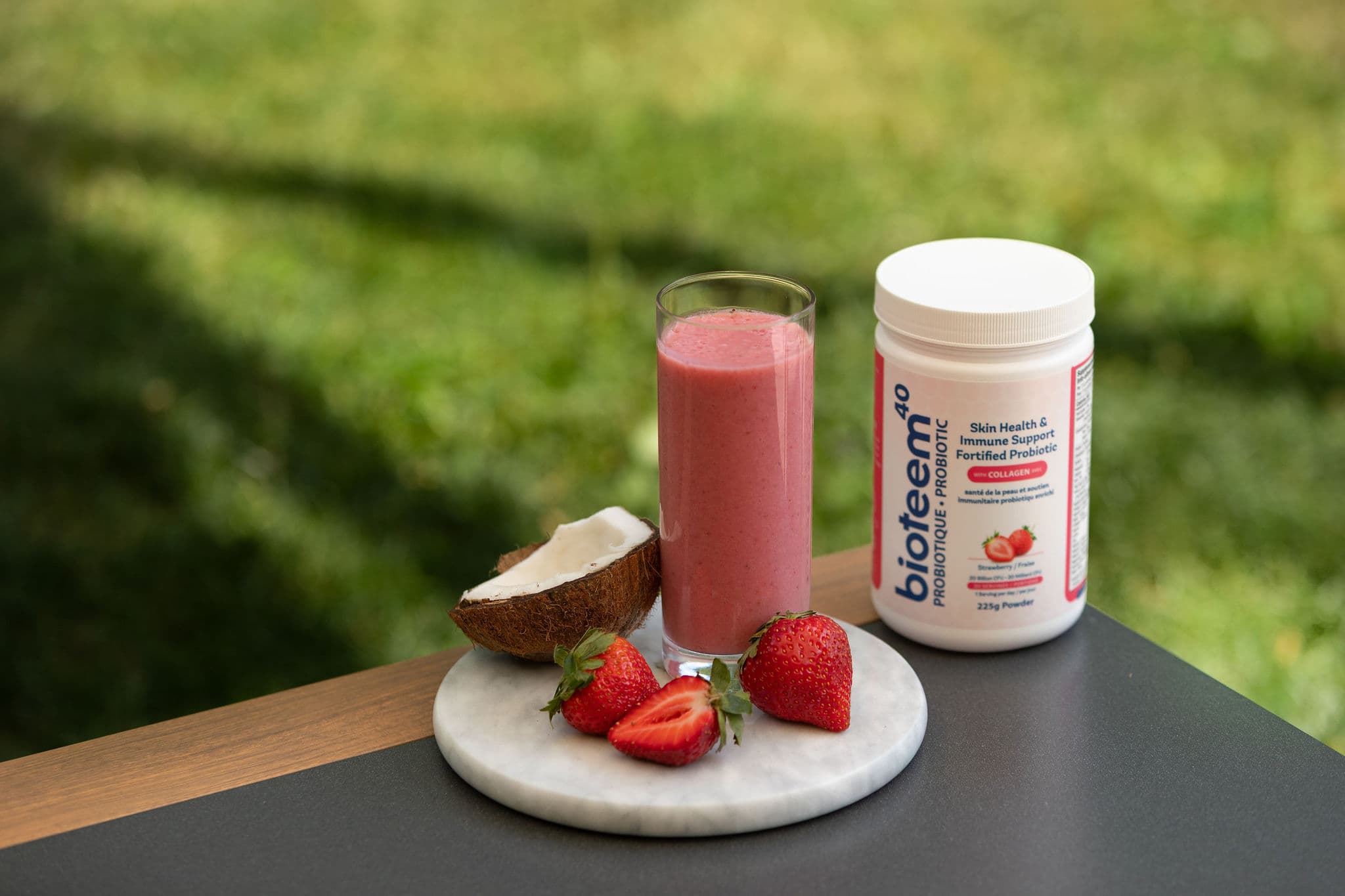 Bioteem products with coconuts on table in a field