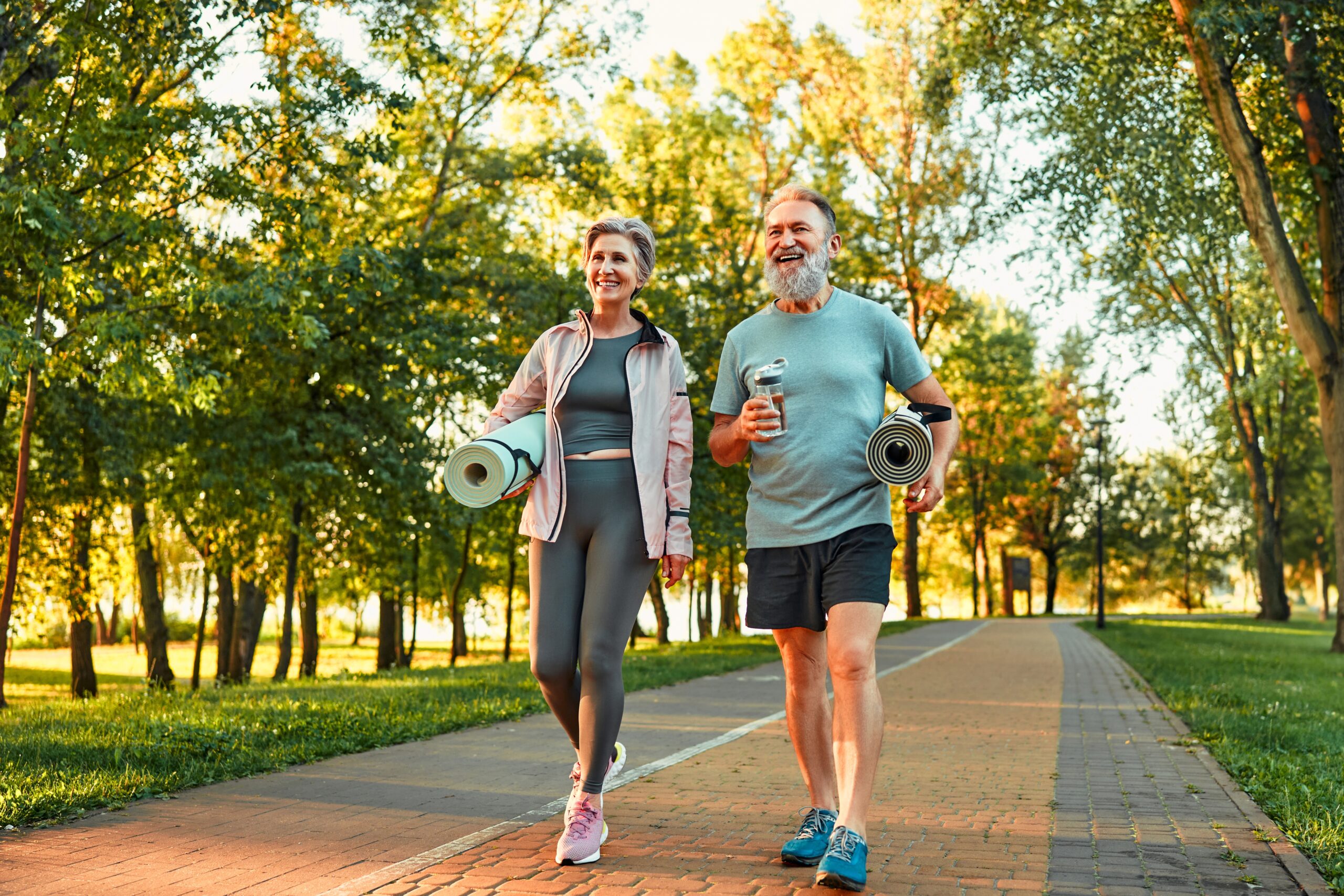 two active older people enjoying a walk in the sun